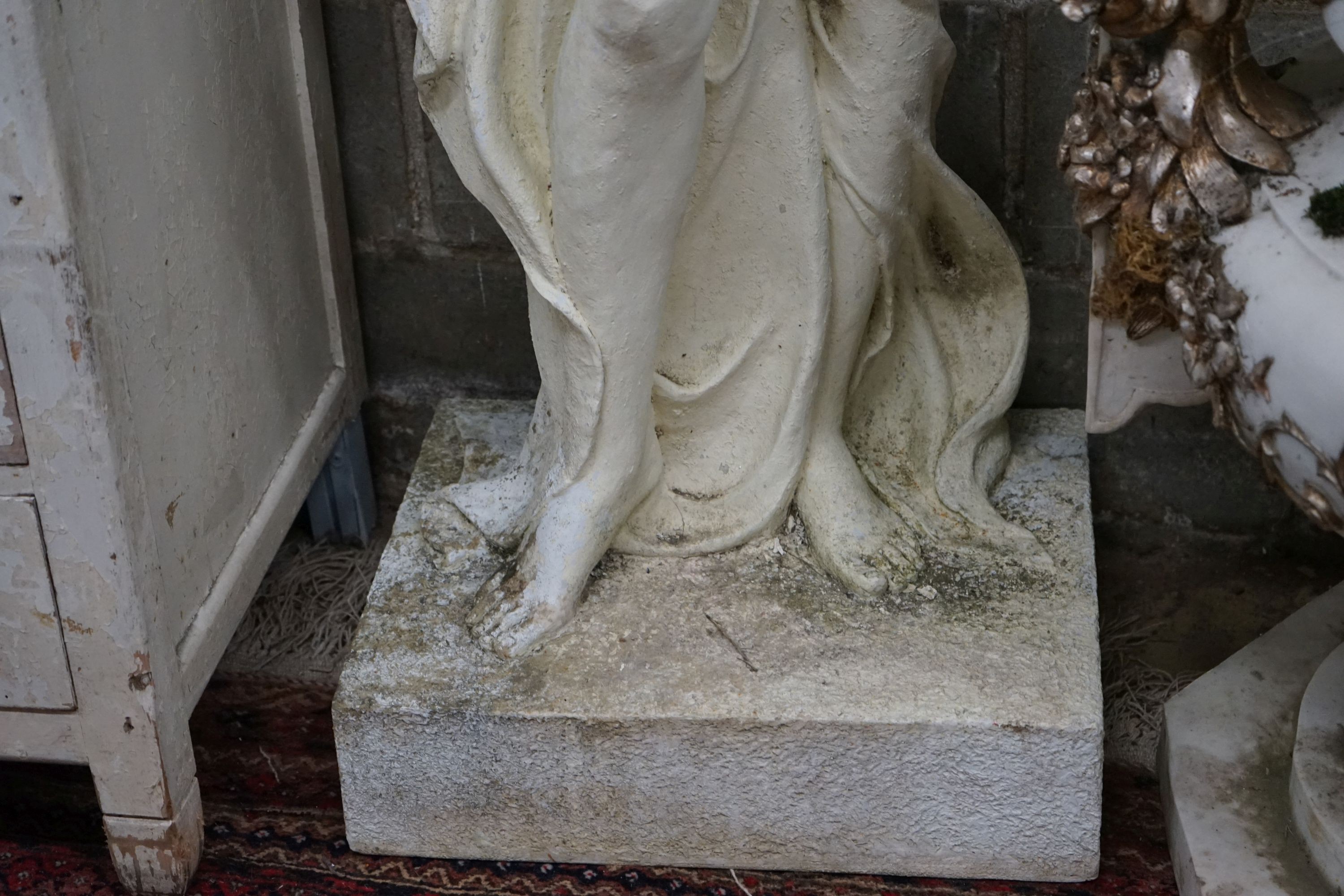 A large painted composition faux marble garden ornament, modelled as a girl with basket of fruit, height 160cm
